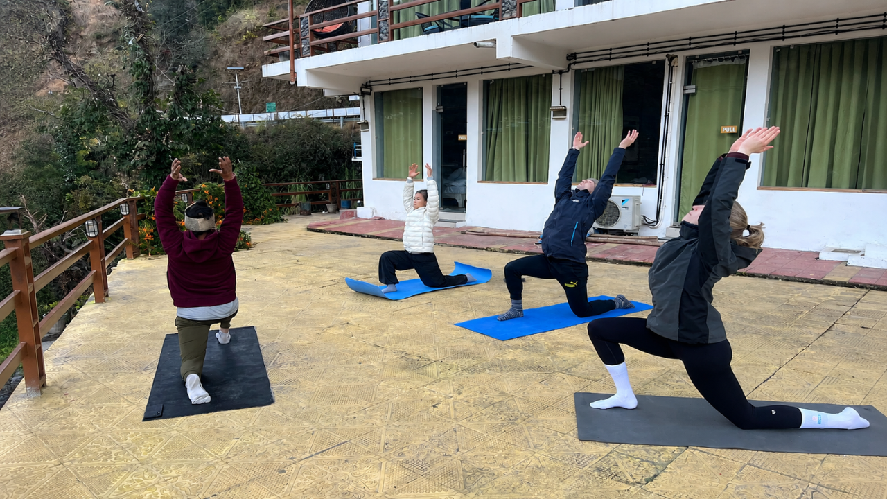 Students practicing outdoor yoga during the 10-Day Himalayan Yoga Immersion Retreat in Rishikesh with mountain surroundings