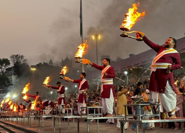 Priests performing evening Ganga Aarti at Triveni Ghat Rishikesh
