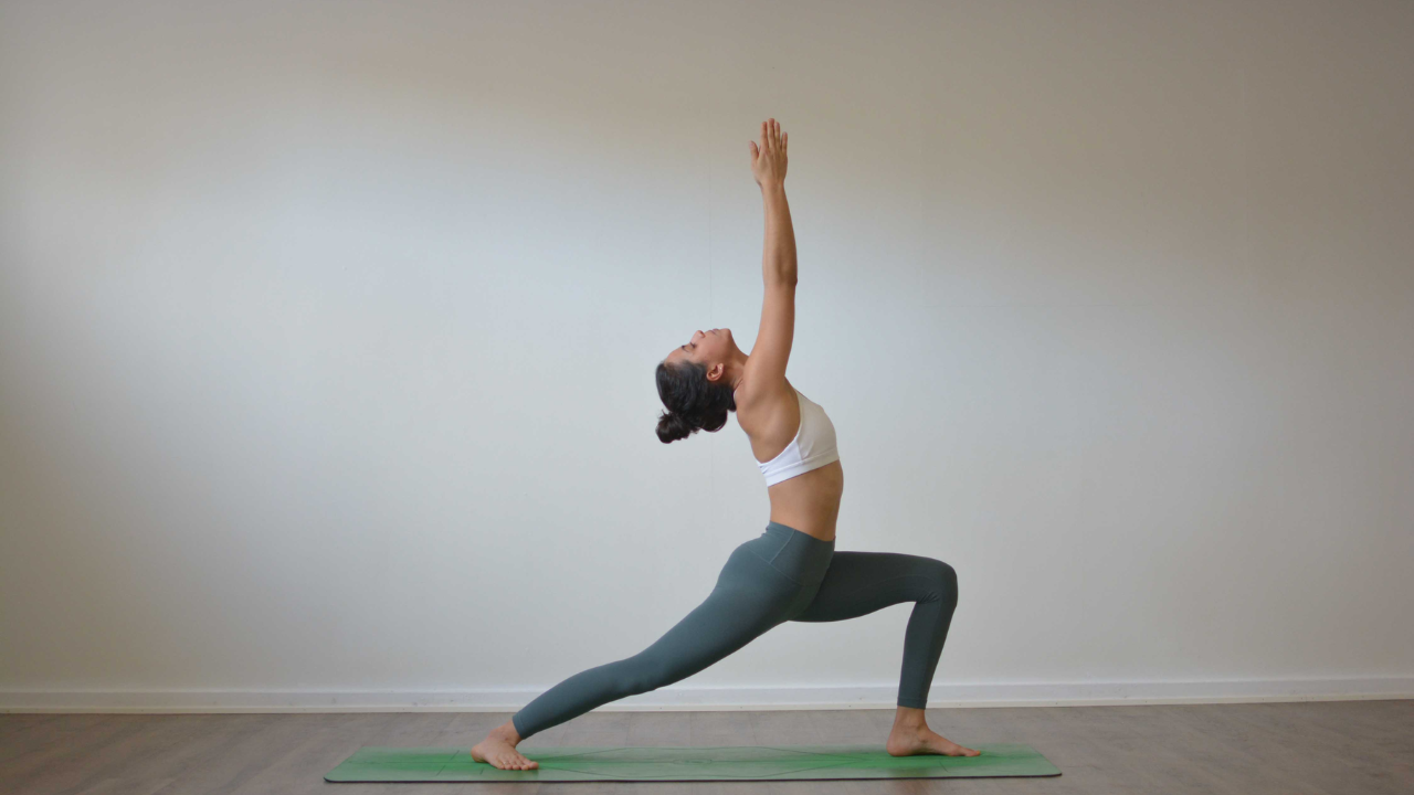 Beginner performing Warrior I Virabhadrasana I pose to build strength and balance