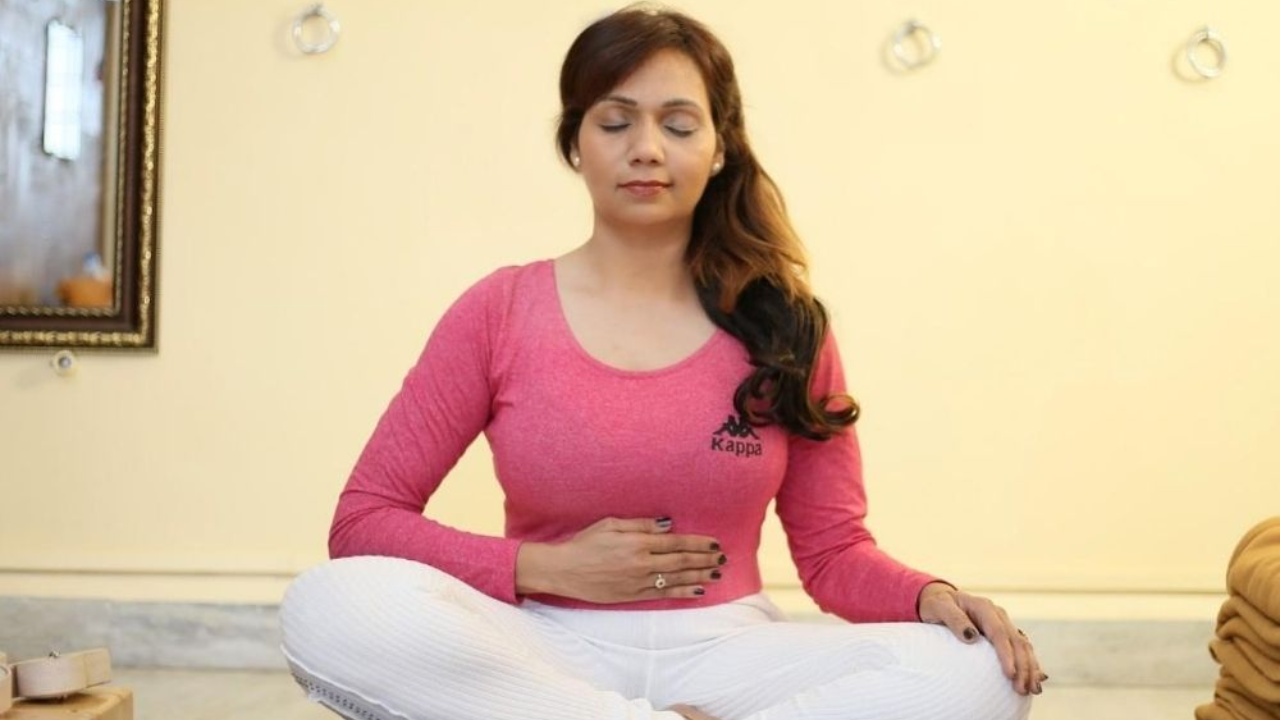 Woman doing Kapalbhati to reduce belly fat and lose weight