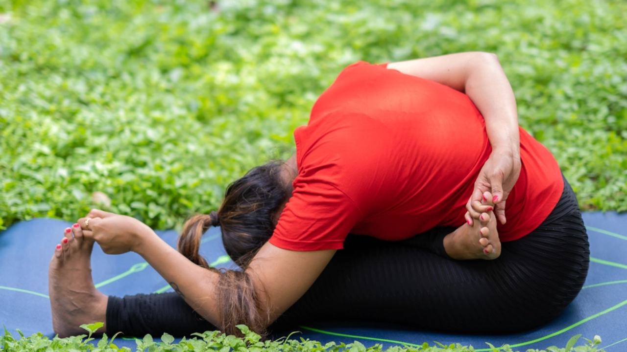 Woman practicing Paschimottanasana for stress relief and mental calmness