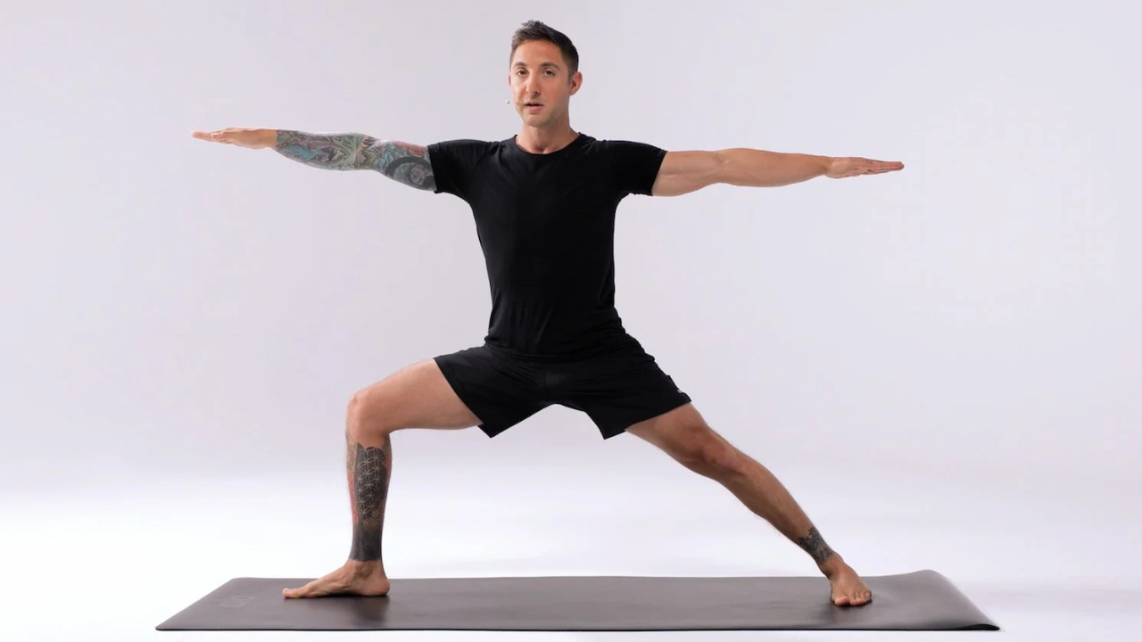 Close up of legs in Warrior II pose showing muscle strength and engagement