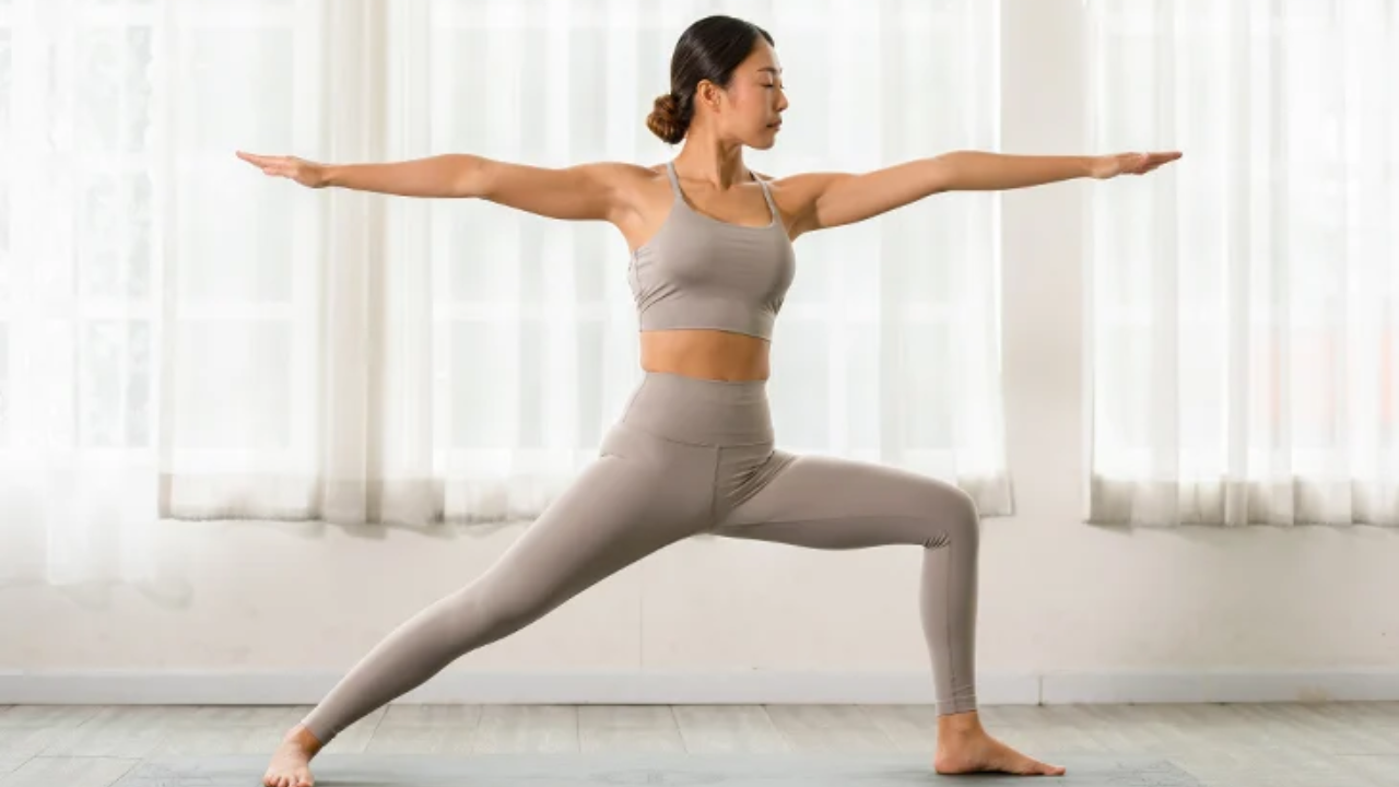 Person practicing Warrior II Virabhadrasana yoga pose for strength and balance